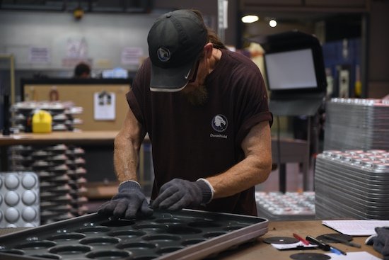 A-TECHNICIAN-PERFORMS-QUALITY-CONTROL-ON-A-FRESHLY-COATED-AMERICAN-PAN-1